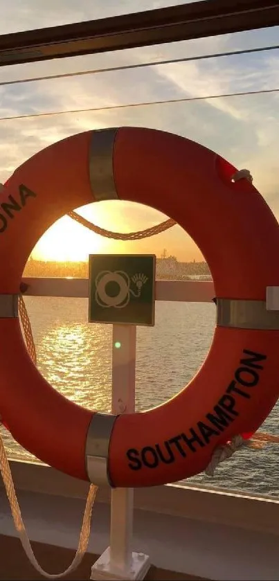 Lifebuoy ring framing a sunset on a calm ocean from a ship deck view.