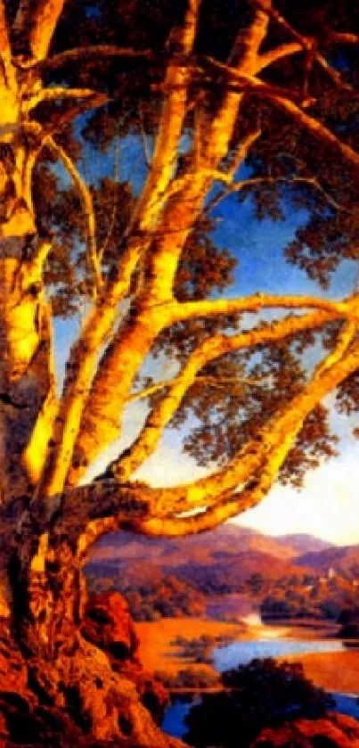 Golden tree at sunset with mountains in background.