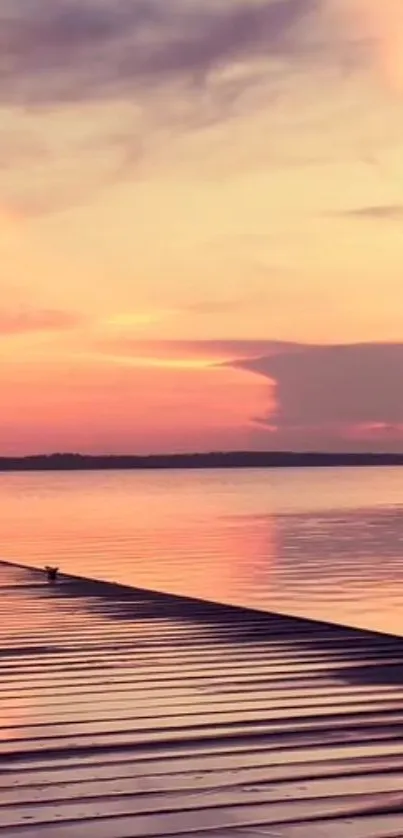 A calming sunset over a tranquil lake with pink and orange reflections.