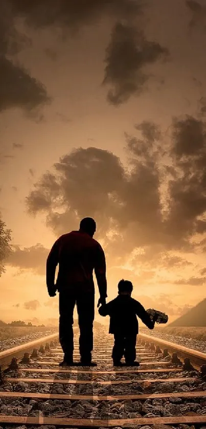 Silhouette of father and child walking on a railroad track at sunset.