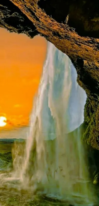 Cascading waterfall during sunset with vibrant orange sky.