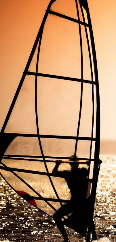 Silhouette of a windsurfer during sunset on the ocean.