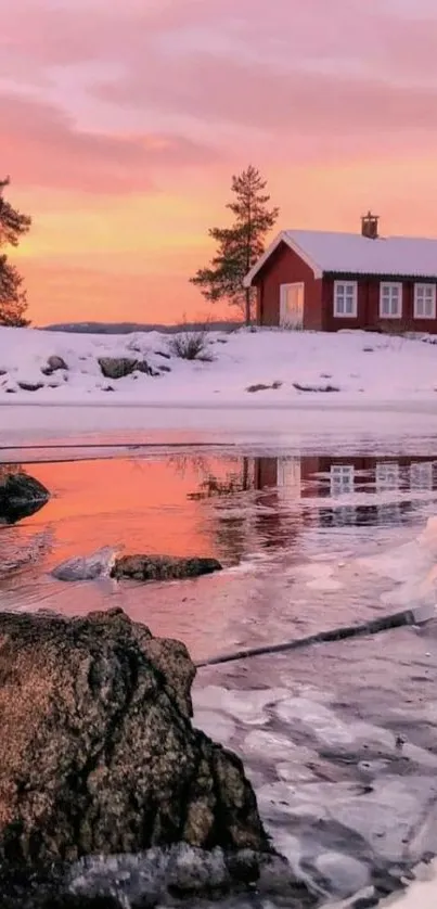 Serene winter lake at sunset with pink skies and a cozy cabin.