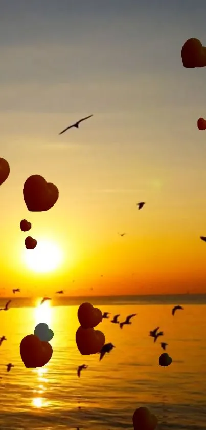 A serene sunset with hearts floating and birds flying over the ocean.