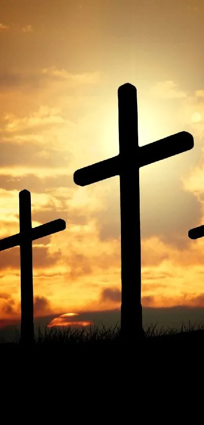 Three crosses silhouetted against a golden sunset sky.