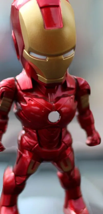 Red and gold superhero figurine wallpaper for mobile.