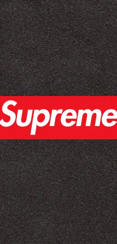 Supreme logo on black textured background wallpaper.