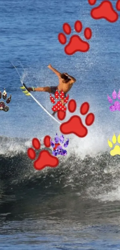 Surfer caught mid-jump with colorful paw prints on a wave.