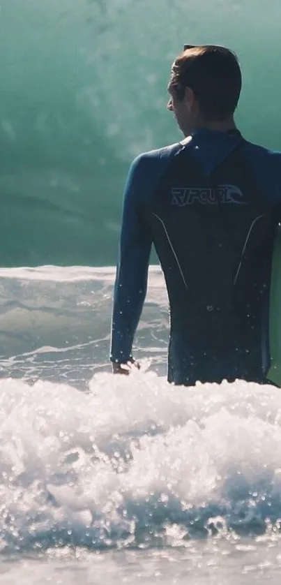 Surfer in wetsuit entering ocean waves, set against teal green sea.