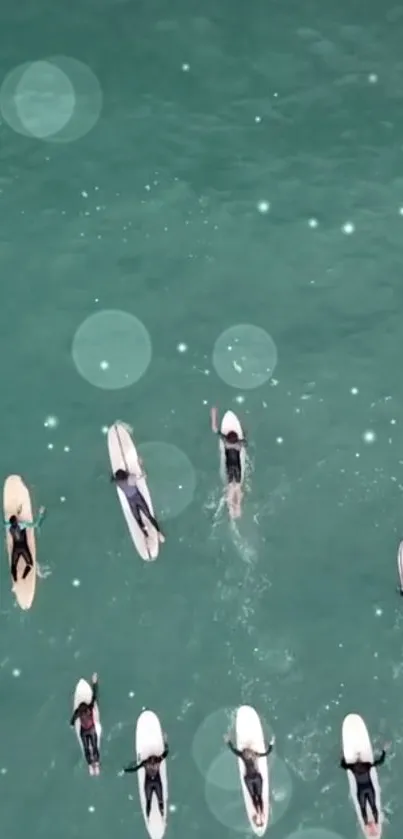 Aerial view of surfers on turquoise ocean.