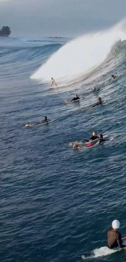 Surfers riding big ocean waves against a scenic coastal backdrop.