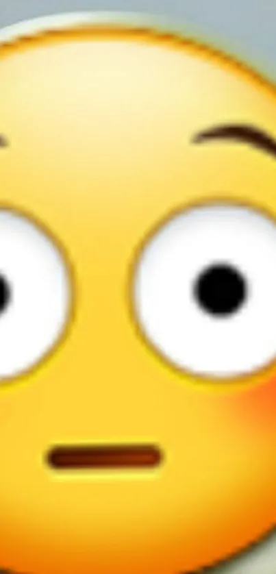 Close-up of a surprised yellow emoji face with wide eyes.