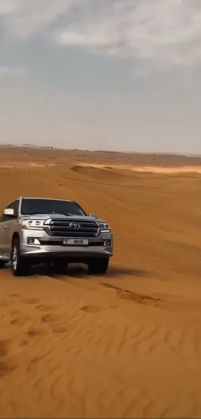 SUV driving through expansive desert sands.