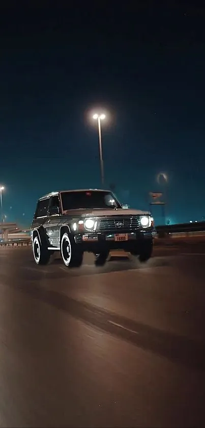 SUV driving at night under city lights on a dimly lit road.