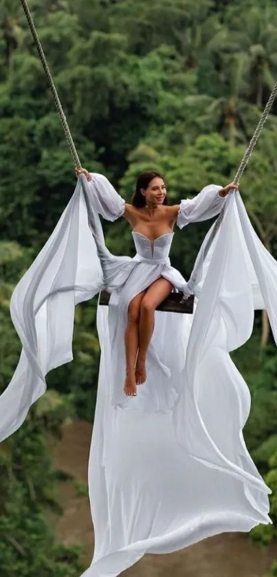 Woman swinging over lush green forest in a white dress.