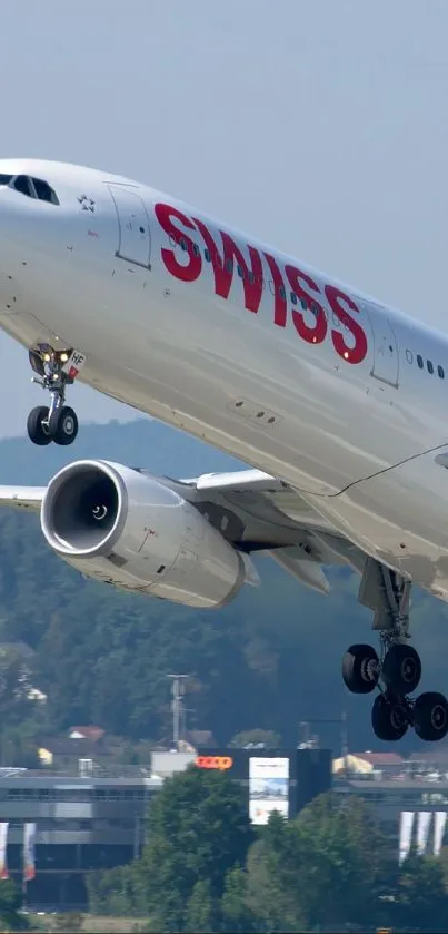 Swiss airplane taking off, set against a clear blue sky.