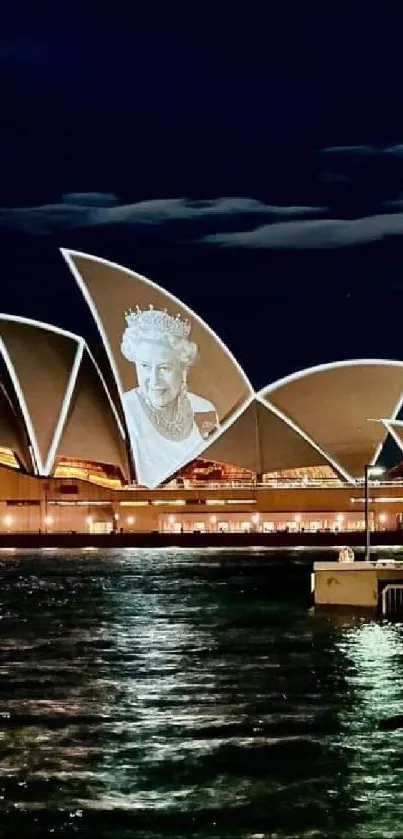 Sydney Opera House illuminated at night over water.