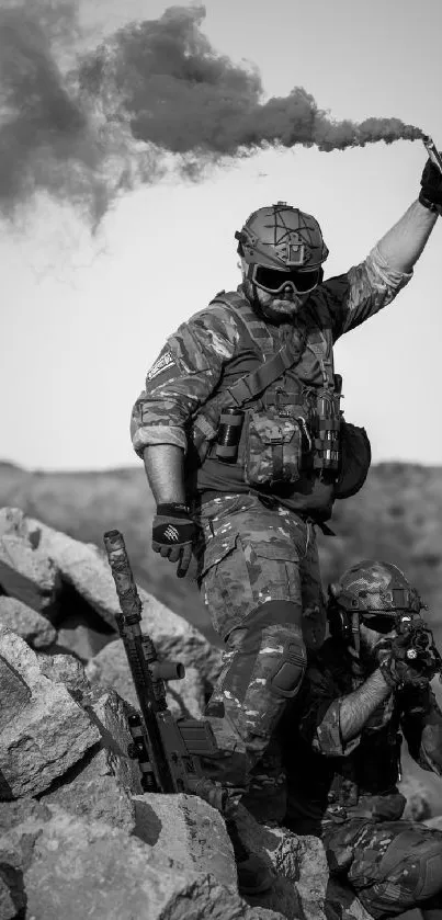 Grayscale wallpaper featuring soldiers with smoke and rocky landscape.