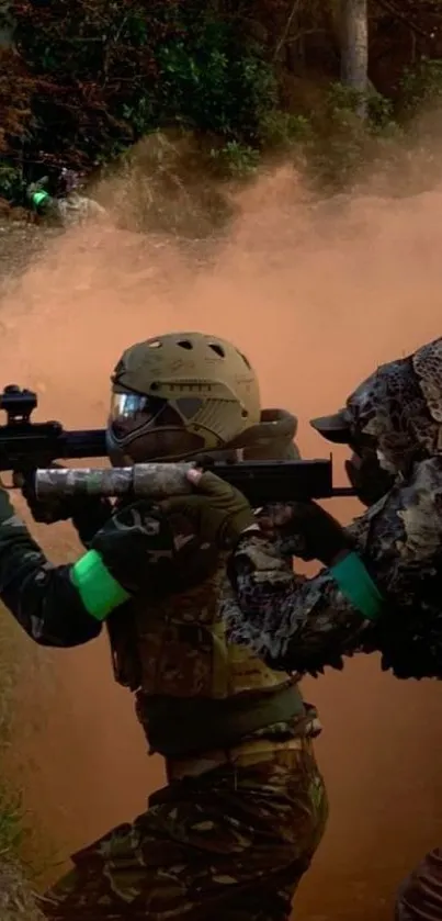 Soldiers in tactical gear amid dust and foliage in a forest.