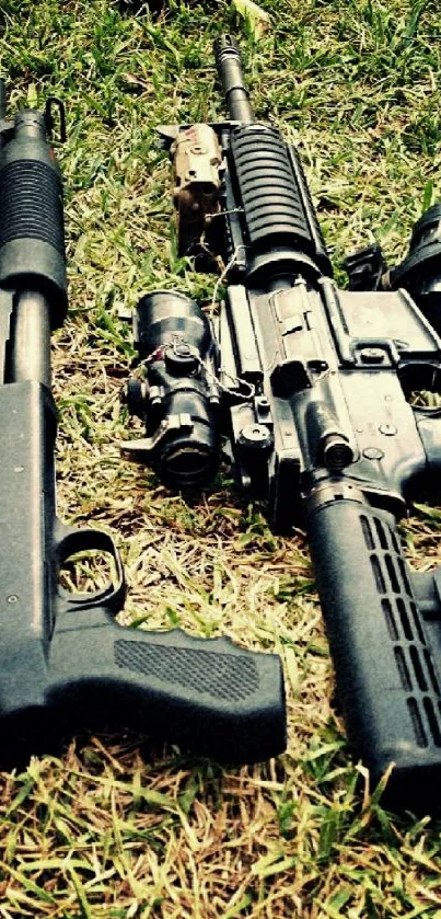 Two tactical firearms resting on grass in a high-resolution mobile wallpaper.