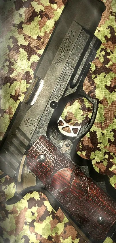 Realistic handgun on camouflage pattern background.