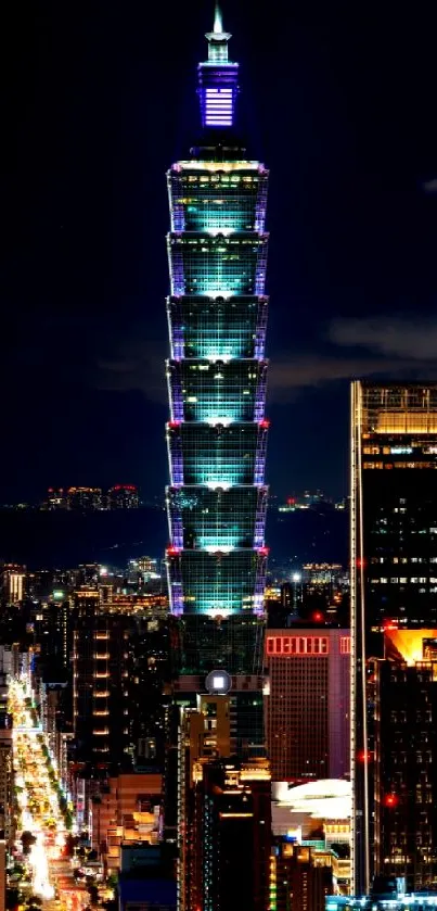 Taipei 101 tower illuminated against the city night skyline.