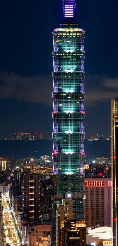 Night view of Taipei 101 skyscraper illuminated in city skyline.