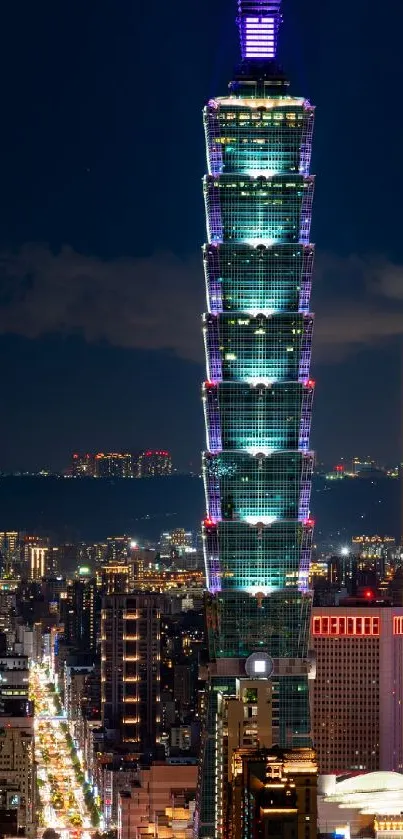 Illuminated Taipei 101 at night with the city skyline in view.