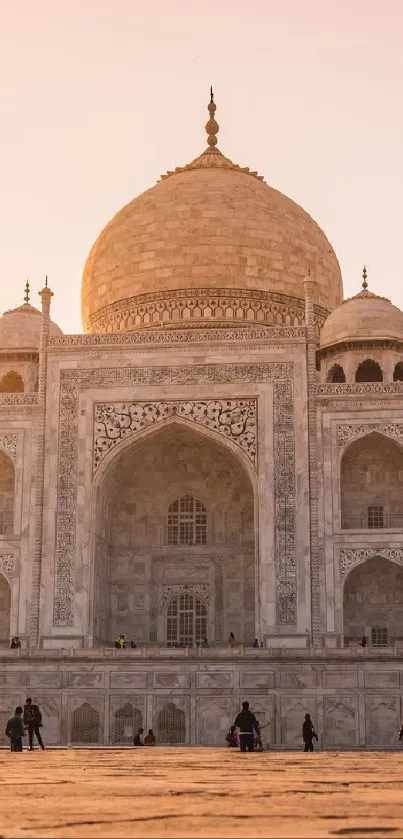 Taj Mahal at sunset with warm hues in a mobile wallpaper format.