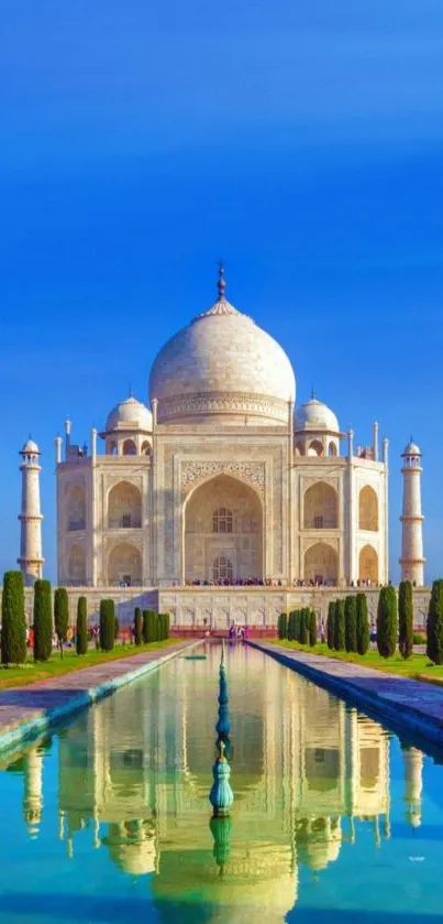 Taj Mahal with reflection under a vibrant blue sky.