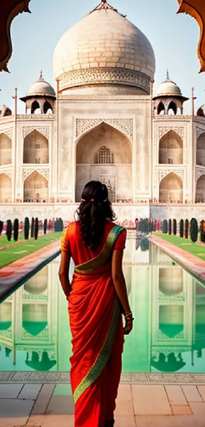 Woman in sari gazing at the Taj Mahal reflection