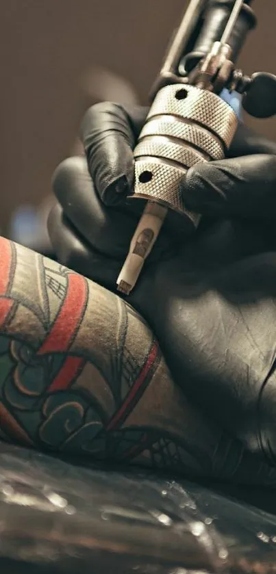 Close-up of a tattoo artist working on a colorful design.