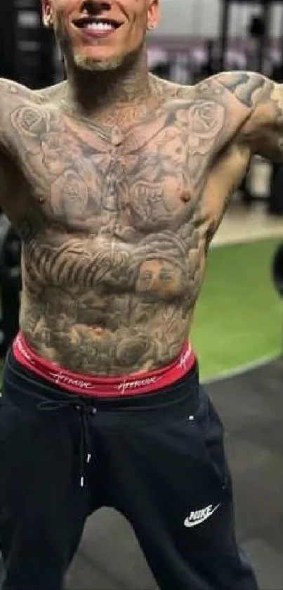 Tattooed athletic person posing in a gym setting.