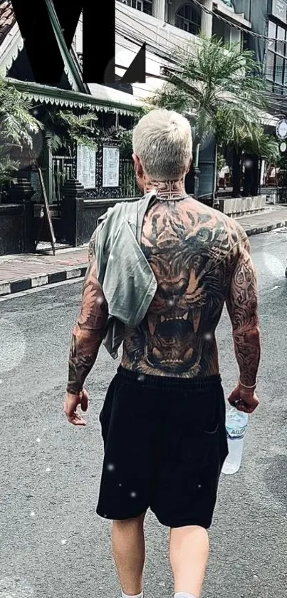 Tattooed individual walking on a city street, showcasing street style and modern art.