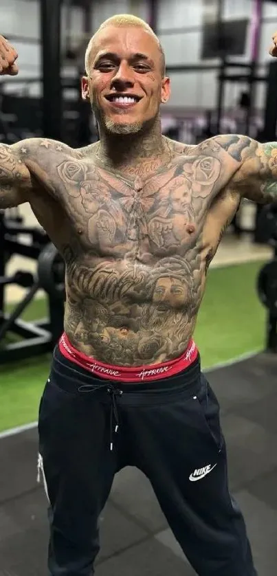 Tattooed person flexing muscles in a gym setting.