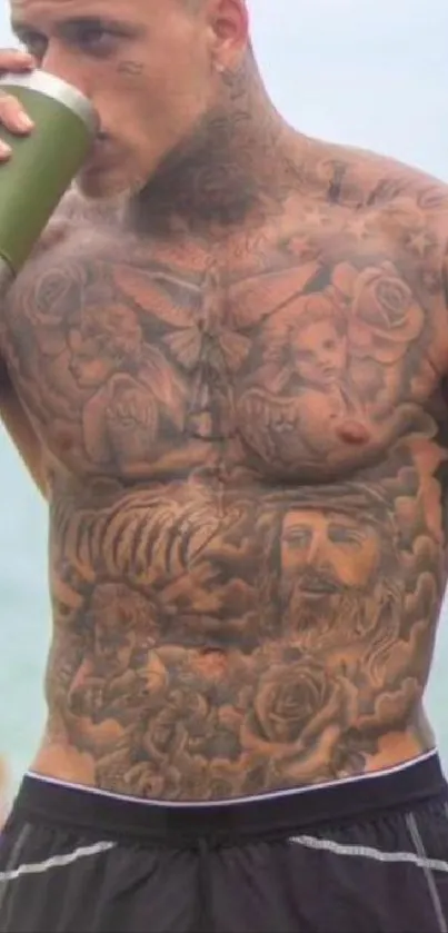 Heavily tattooed torso with beach backdrop.