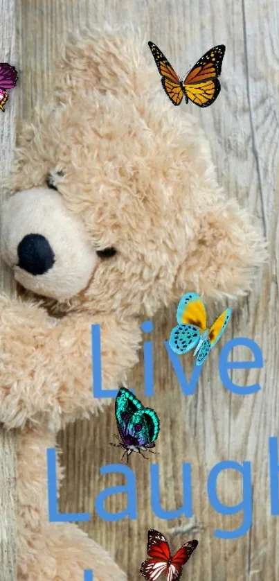 Teddy bear with butterflies and inspiring text on wood background.