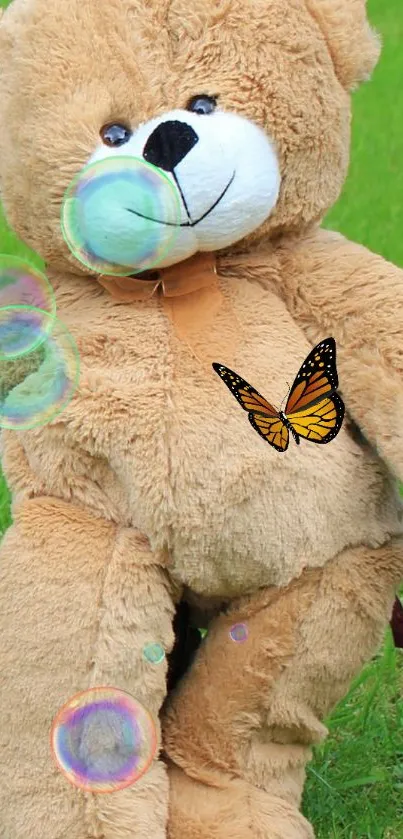 Teddy bear on grass with butterflies and bubbles.