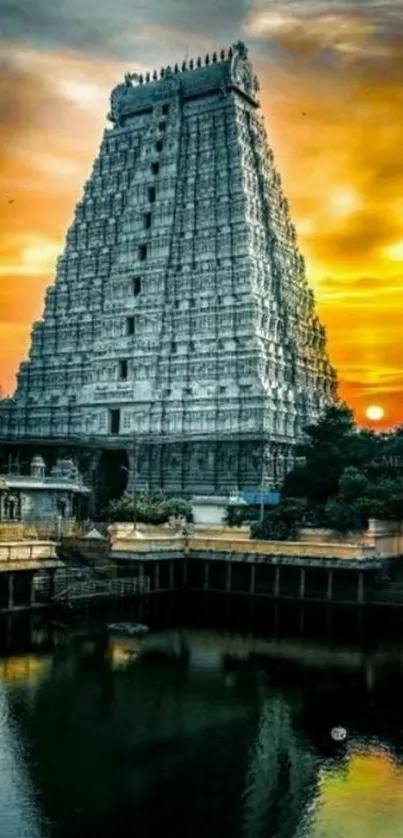 Temple reflecting in water at sunset with orange skies.