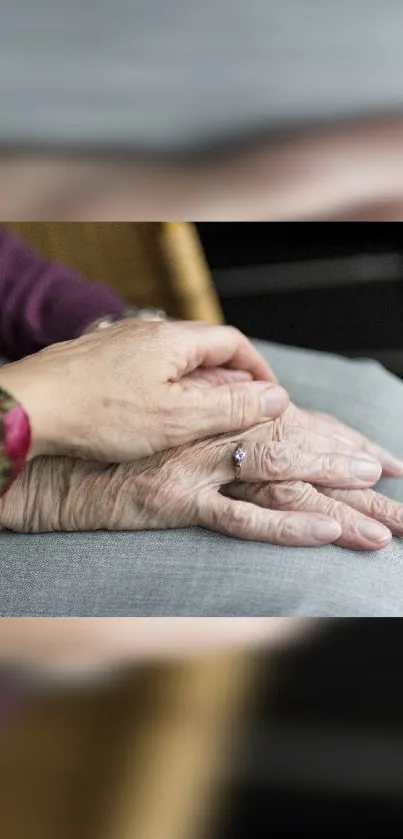 Hands holding softly, symbolizing love and care, on a comforting grey background.