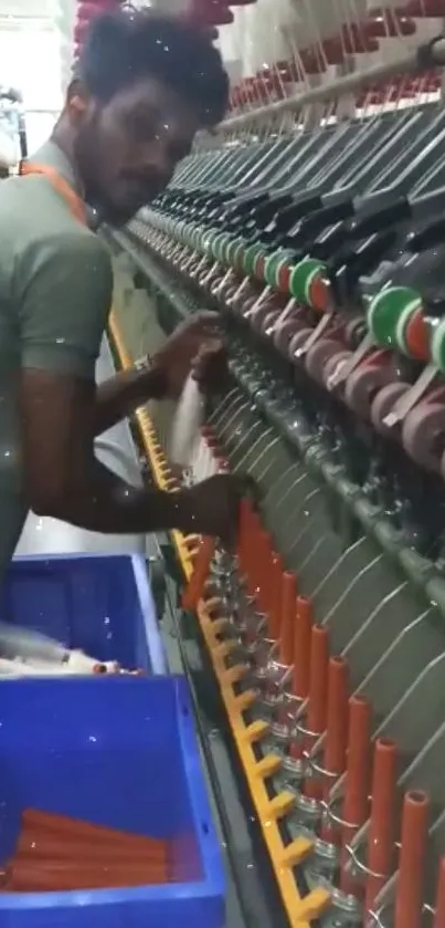 Textile worker operating a spinning machine in an industrial setting.