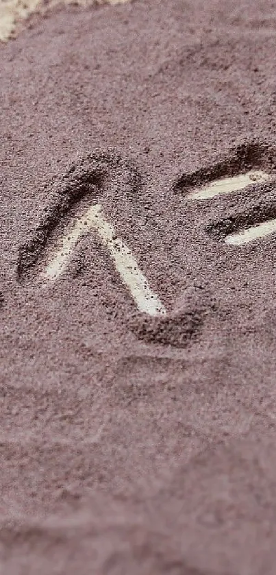 Close-up of intricate sand texture in taupe hues on mobile wallpaper.