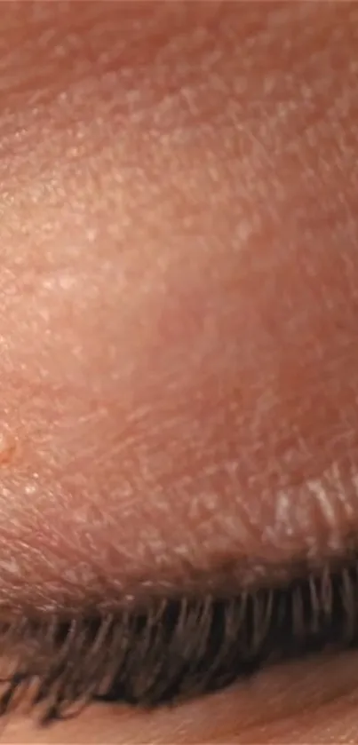 Close-up view of textured human skin with eyelash detail.