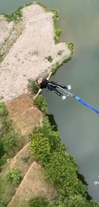 Bungee jumper over scenic river landscape.