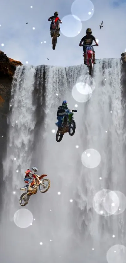 Motocross riders jumping in front of a majestic waterfall.