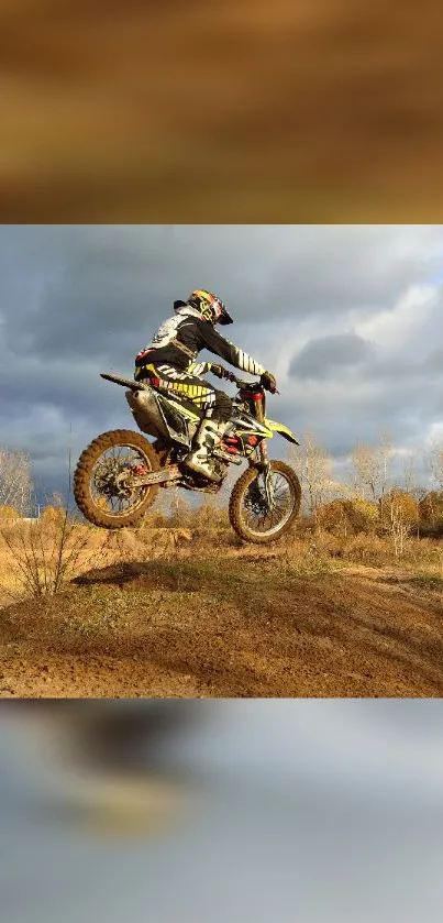 Motocross rider mid-air over dirt track, dynamic scene.