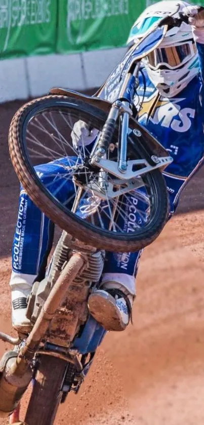 Motorcycle performing an impressive wheelie on a dirt track, capturing dynamic motion.