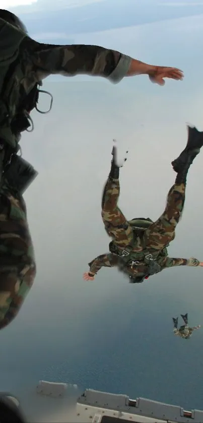 Skydivers in action over ocean, high-altitude adventure captured.