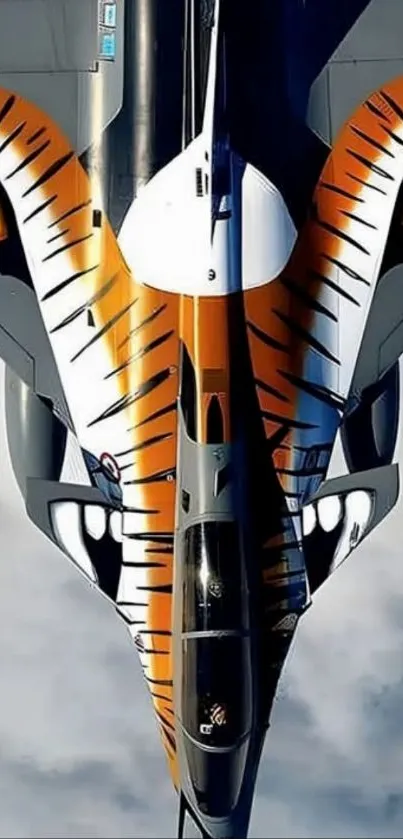 Fighter jet painted with tiger stripes flying in clear sky.
