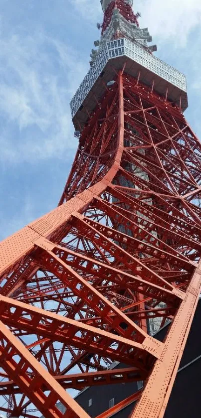 Striking red Tokyo Tower against blue sky.